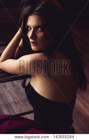 closeup shot of young brunette model posing in burlesque fitting room