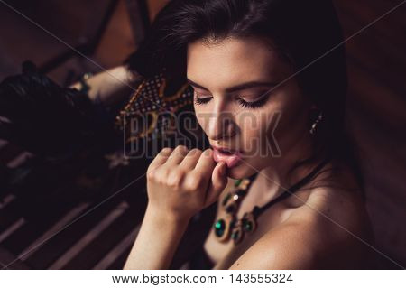 closeup shot of young brunette model posing in burlesque fitting room