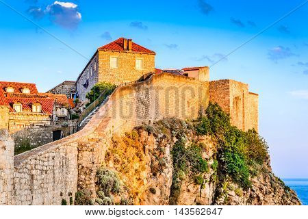 Dubrovnik Croatia. Sunset golden light over Old Town roofs and fortress walls of Ragusa (Duvrovnik).