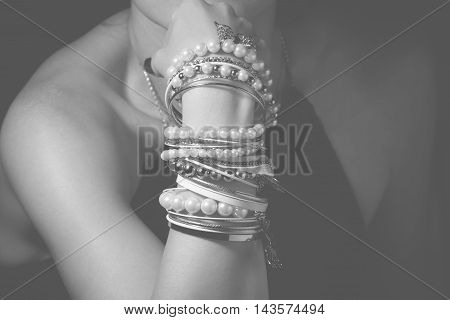 Collection of bracelets on the hands of a woman