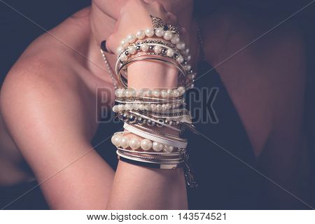 Collection of bracelets on the hands of a woman