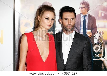 NEW YORK-JUNE 25: Behati Prinsloo (L) and Adam Levine attend the New York premiere of 