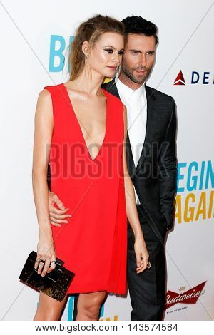 NEW YORK-JUNE 25: Behati Prinsloo (L) and Adam Levine attend the New York premiere of 