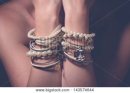 Collection of bracelets on the hands of a woman