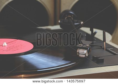 Old vinyl player and records on the table