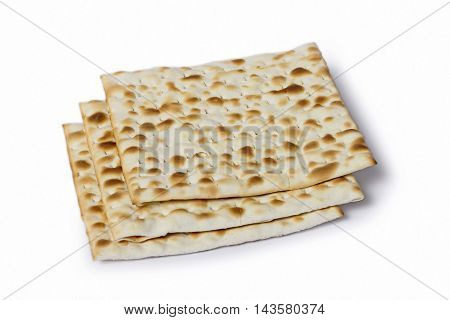 Multiple machine made matza flatbreads lying one over another composition isolated over the white background