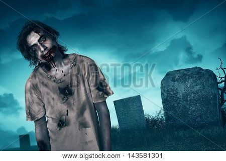 Zombie walking with creepy expression graveyard and fog background