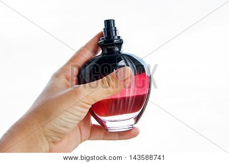 female perfume in hand in white background