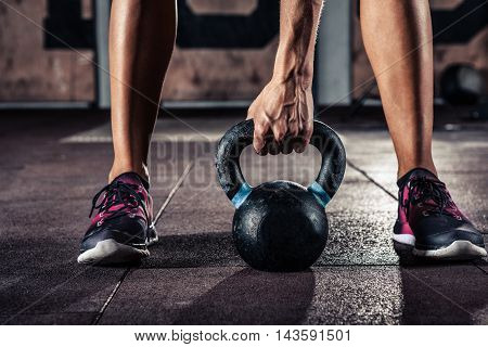 fit kettlebell training in gym closeup. Black and white