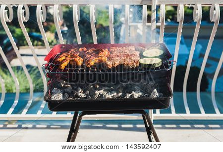 Delicious Meat On Barbecue Grill With Coal On Balcony.