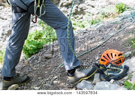 Climber man belaying with climbing gear equipment