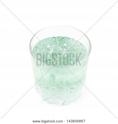 Rocks old fashioned glass filled with the carbonated green lemonade water isolated over the white background
