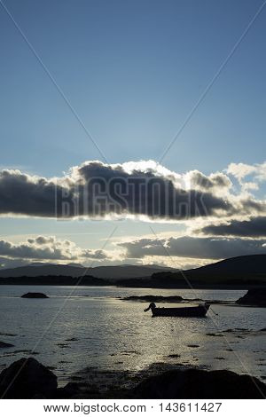 boat in a quiet bay near kenmare on the wild atlantic way ireland at sunset
