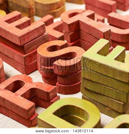 Surface coated with the multiple painted wooden block letters as an abstract backrop composition