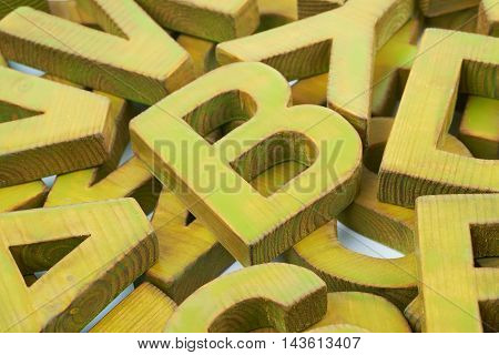 Surface coated with the multiple painted wooden block letters as an abstract backrop composition