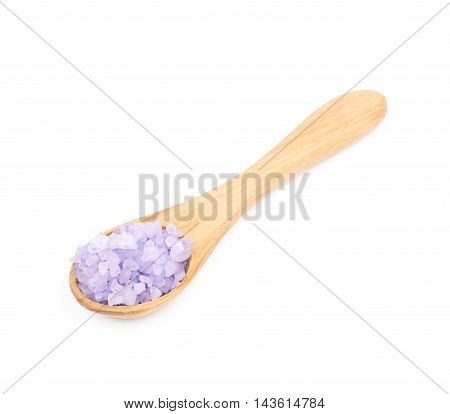 Wooden spoon full of aromatic purple salt crystals isolated over the white background