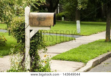 American outdoor metal mailbox on wooden support