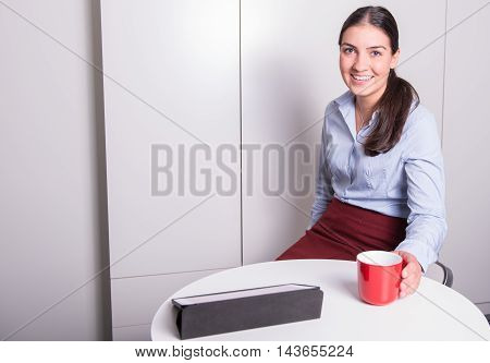smart professonal woman is having a coffee break in the office