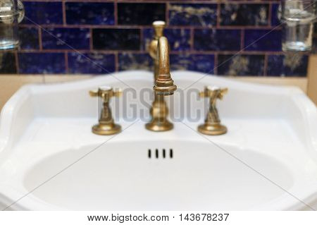turned off bronzy metal tap of retro design