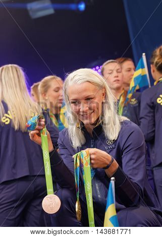 STOCKHOLM, SWEDEN - AUG 21, 2016: Famous swimmer Sarah Sjostrom showing her medals from the olympic games when the swedish olympics are celebrated in Kungstradgarden, Stockholm, Sweden, August 21 2016
