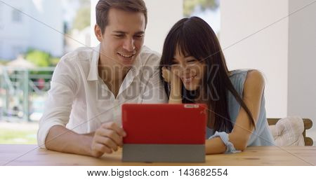 Smiling couple using a tablet computer together