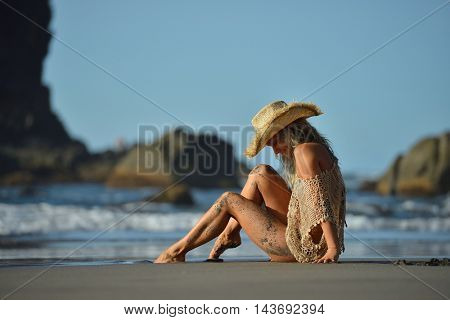 young woman relaxing on the beach in summer day