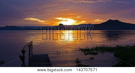 Golden sunset on the Lake Taal Philippines. Taal Island is in close proximity to the industrial area of Manilla.