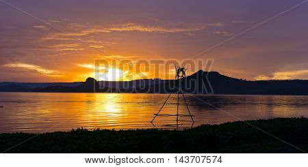 Tropical golden sunset on the Lake Taal Luzon Island Philippines. Horizon over the mountains and beautiful lake at sunset.