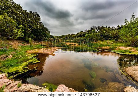 Beautiful Rocky Creek in Texas with Various Grasses and a Few Wildflowers on the Famous Willow City Loop