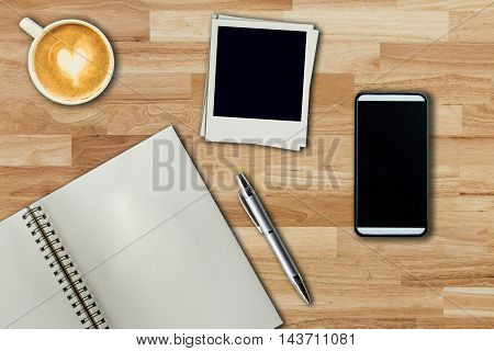 Mobile Phone, Notebook Pen, Photo Frame And Coffee Cup On Office Wooden Table With Copy Space.