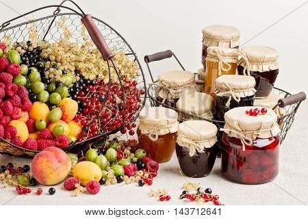 Summer fruits and berries - red black and white currants raspberries gooseberries peaches and apricots. Selective focus.