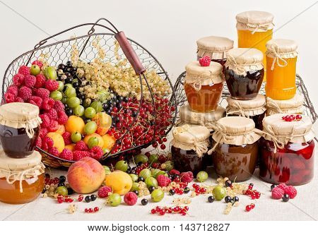 Summer fruits and berries - red black and white currants raspberries gooseberries peaches and apricots. Selective focus.