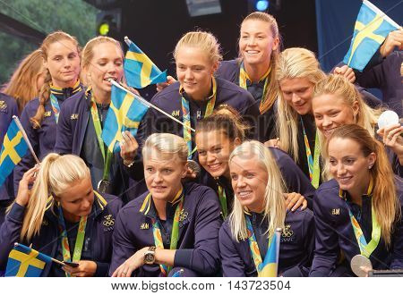STOCKHOLM SWEDEN - AUG 21 2016: Swedish female soccer team showing their silver medals from the olympic games when the swedish olympic athletes are celebrated in Kungstradgarden StockholmSwedenAugust 212016
