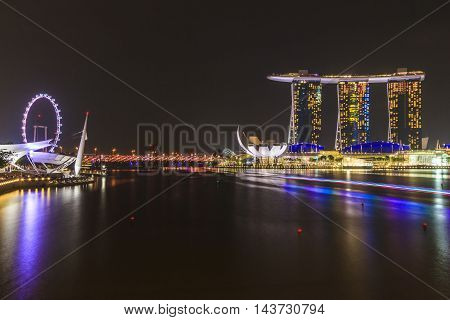 SINGAPORE SINGAPORE - SEPTEMBER 28 2013 : Night view of Marina Bay Sands hotel Singapore flyer Art Science Museum and Helix bridge all located around Marina Bay a famous tourist attractions in Singapore.