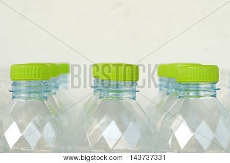 side view of white plastic bottle with green lid