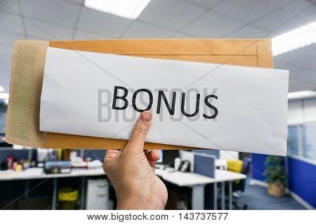 Concept of bonus by pulling paper of bonus from the envelope
