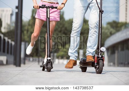 Nice time spending. Pleasant friends using scooter while riding it and resting together