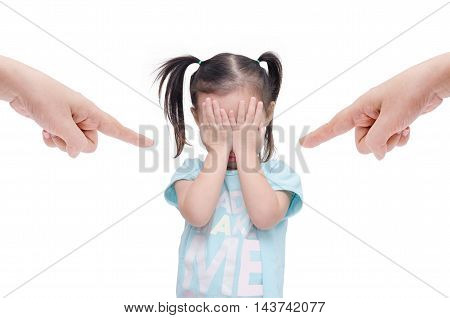 Little asian girl crying while parents scold her over white