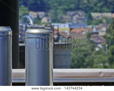 Industrial chimney with flackering hot air on industrial building