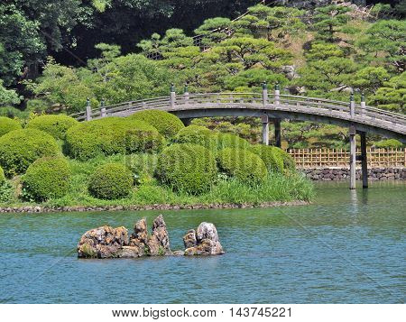 A wooden bridge - Engetsukyo in Ritsurin Garden in Takamatsu city, Kagawa Prefecture, Japan. Ritsurin Garden is one of the most famous historical gardens in Japan.