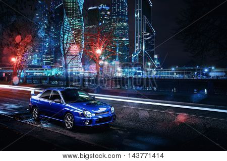 Moscow, Russia - November 21, 2015: Car Subaru Impreza WRX stand in Moscow city near modern buildings at night