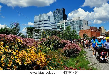 New York City - August 3 2013 People strolling along the High Line Park built on a historic elevated freight train rail line on the West Side of Manhattan