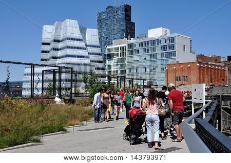 New York City - August 27 2010: View looking north along the High Line Park built atop a 1930's freight rail line on Manhattan's West Side with Frank Gehry's 2007 IAG Building on the left