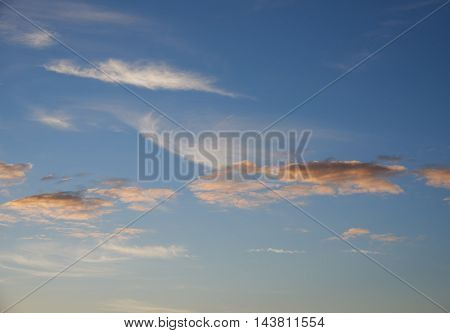 Cumulus and cirrus clouds sundown. Clouds of red pink and orange. Background