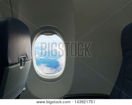 Blue sky and white cloud view from window of airplane. Travel vacation and journey concept.