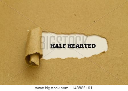 HALF HEARTED word written under torn paper.