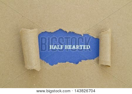 HALF HEARTED word written under torn paper.
