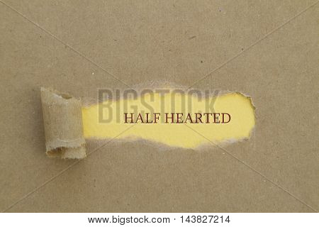 HALF HEARTED word written under torn paper.