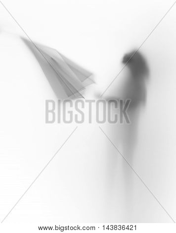 Diffuse body slihouette of a young girl with umbrella