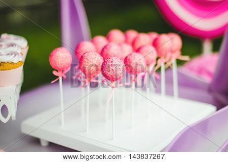 Sweet pink lollipops balls on holiday table